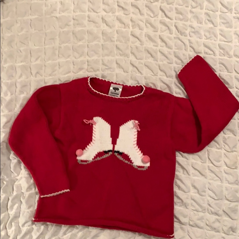 Red sweater with ice skates on front